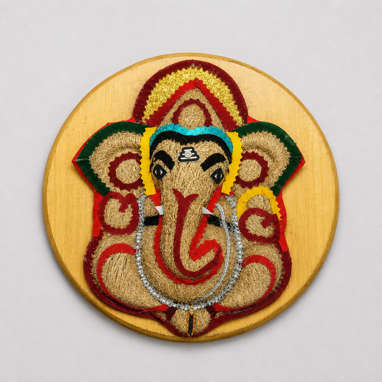 Handcrafted Straw & Fabric Ganesha Wall Hanging – Round Wooden Decor